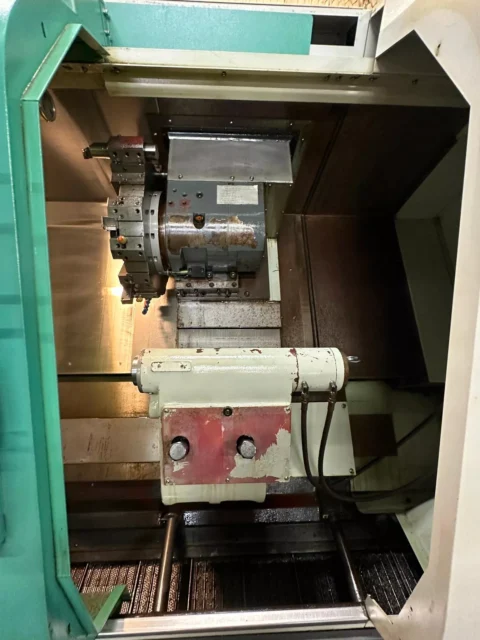 Used YANG ML-300 CNC Turning Center work area with turret and tailstock – SKU 50137